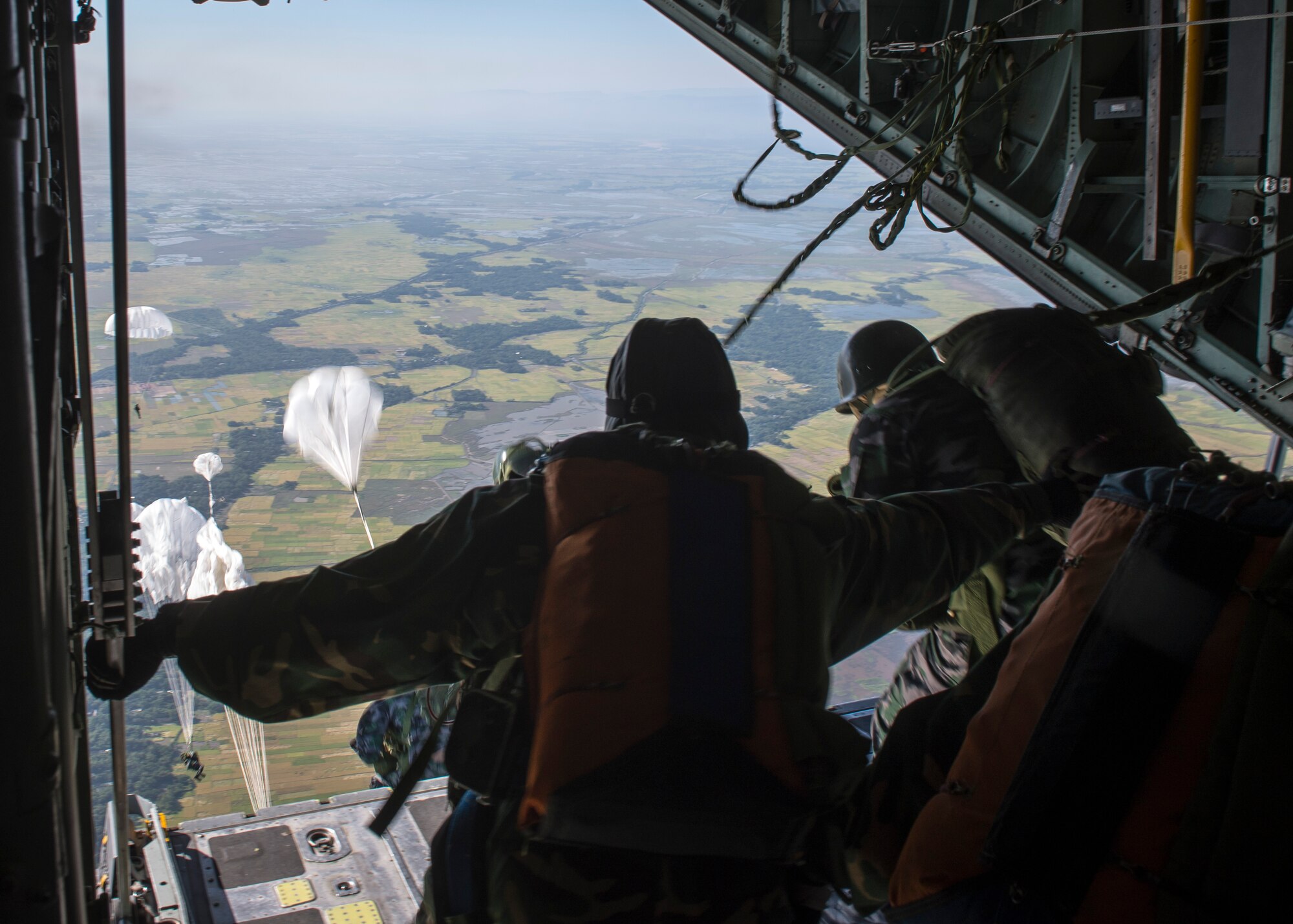 Bangladeshi paratroopers jump from a U.S. C-130 Hercules during exercise Cope South over Bangladesh, Nov. 10, 2013. Cope South is designed to provide Bangladeshi and U.S. forces the opportunity to strengthen relations and promote interoperability. (U.S. Air Force photo by Captain Raymond Geoffroy/Released)