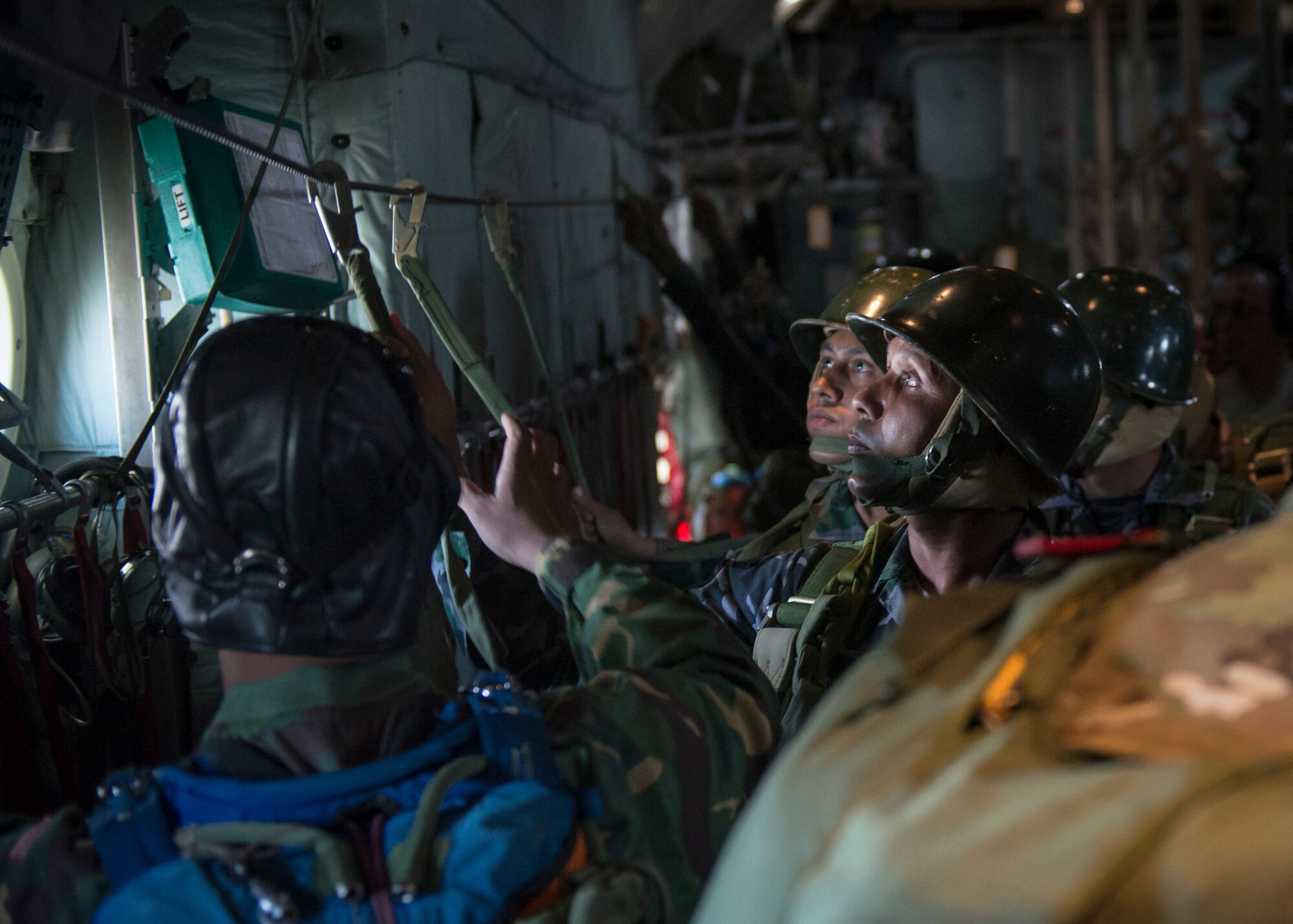 Bangladeshi paratroopers connect to a static aboard a U.S. C-130 Hercules during exercise Cope South over Bangladesh, Nov. 10, 2013. Cope South is designed to provide Bangladeshi and U.S. forces the opportunity to strengthen relations and promote interoperability. (U.S. Air Force photo by Captain Raymond Geoffroy/Released)