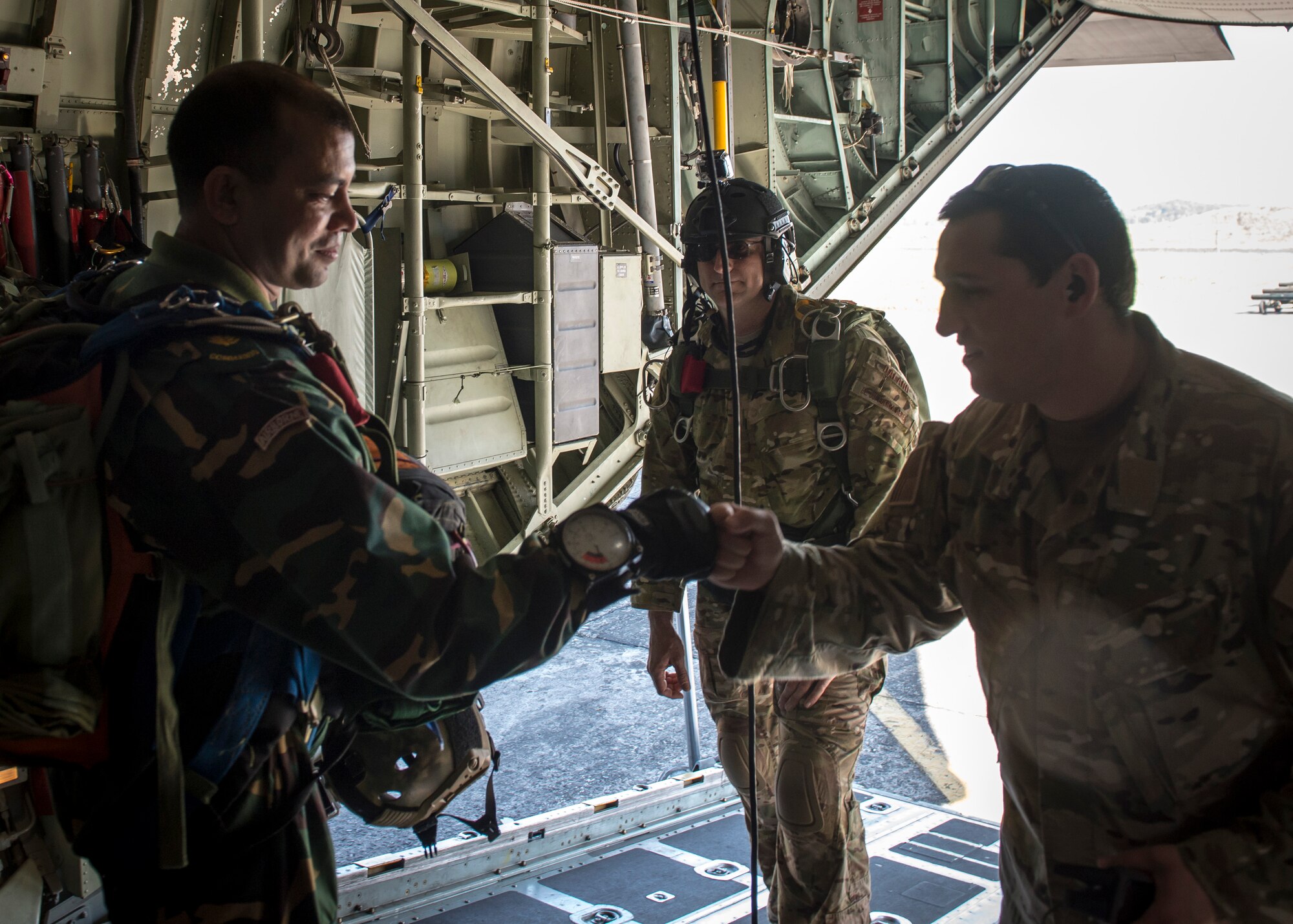 A Bangladeshi Commando exchanges a fist bump with a U.S. Jumpmaster aboard a U.S. C-130 Hercules before a bilateral para-drop mission during exercise Cope South in Bangladesh, Nov. 10, 2013. The exercise is designed to cultivate common bonds, foster goodwill, and improve readiness and compatibility between members of the Bangladesh and U.S. Air Force. (U.S. Air Force photo by Captain Raymond Geoffroy/Released)