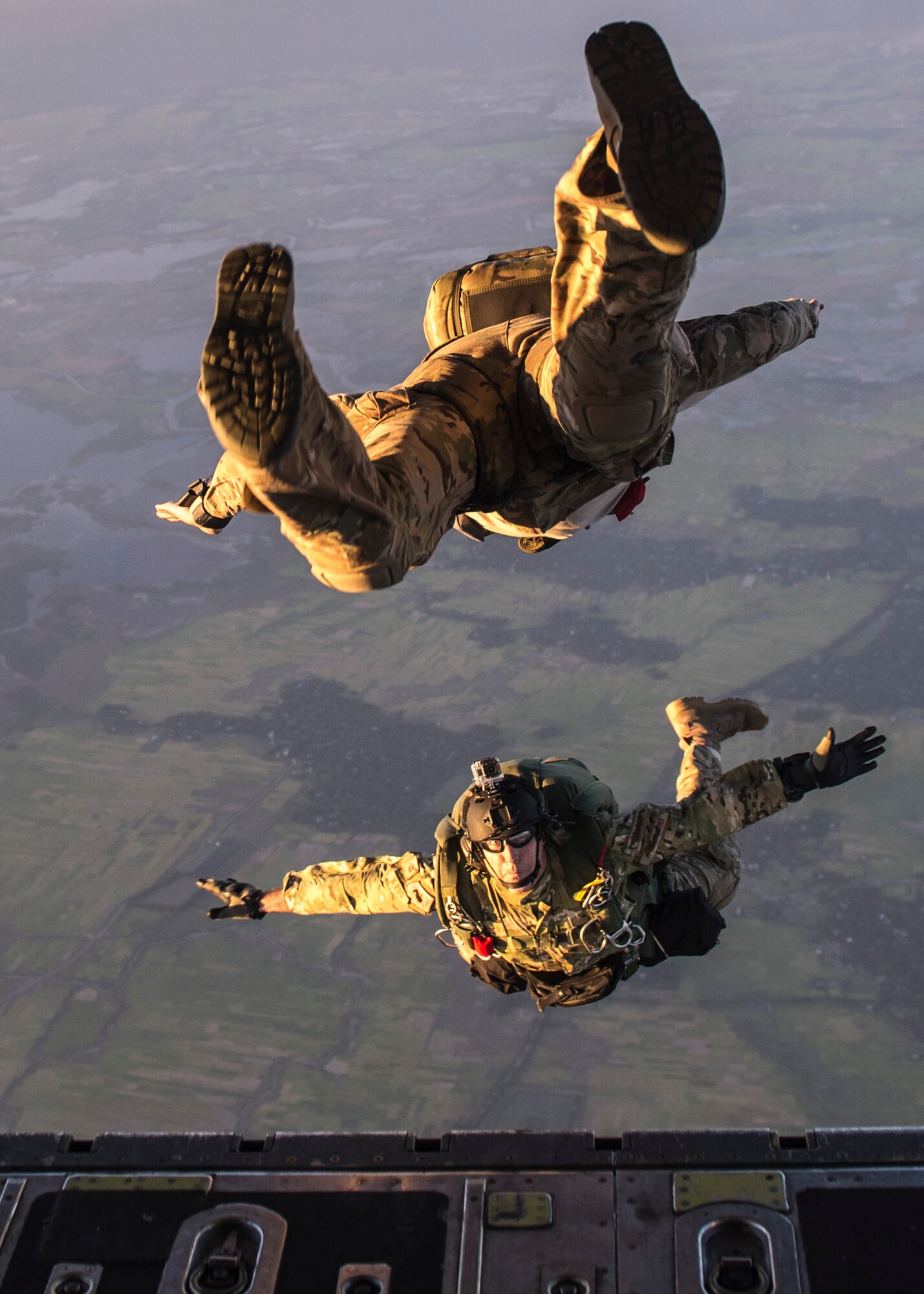 U.S. Airmen jump from a C-130 Hercules during exercise Cope South over Bangladesh, Nov. 9, 2013. Approximately 80 U.S. Airmen and 3 C-130s are teaming up with Bangladeshi Airmen to exchange airlift expertise through a series of missions and subject-matter expert exchanges. (U.S. Air Force photo by Captain Raymond Geoffroy/Released)