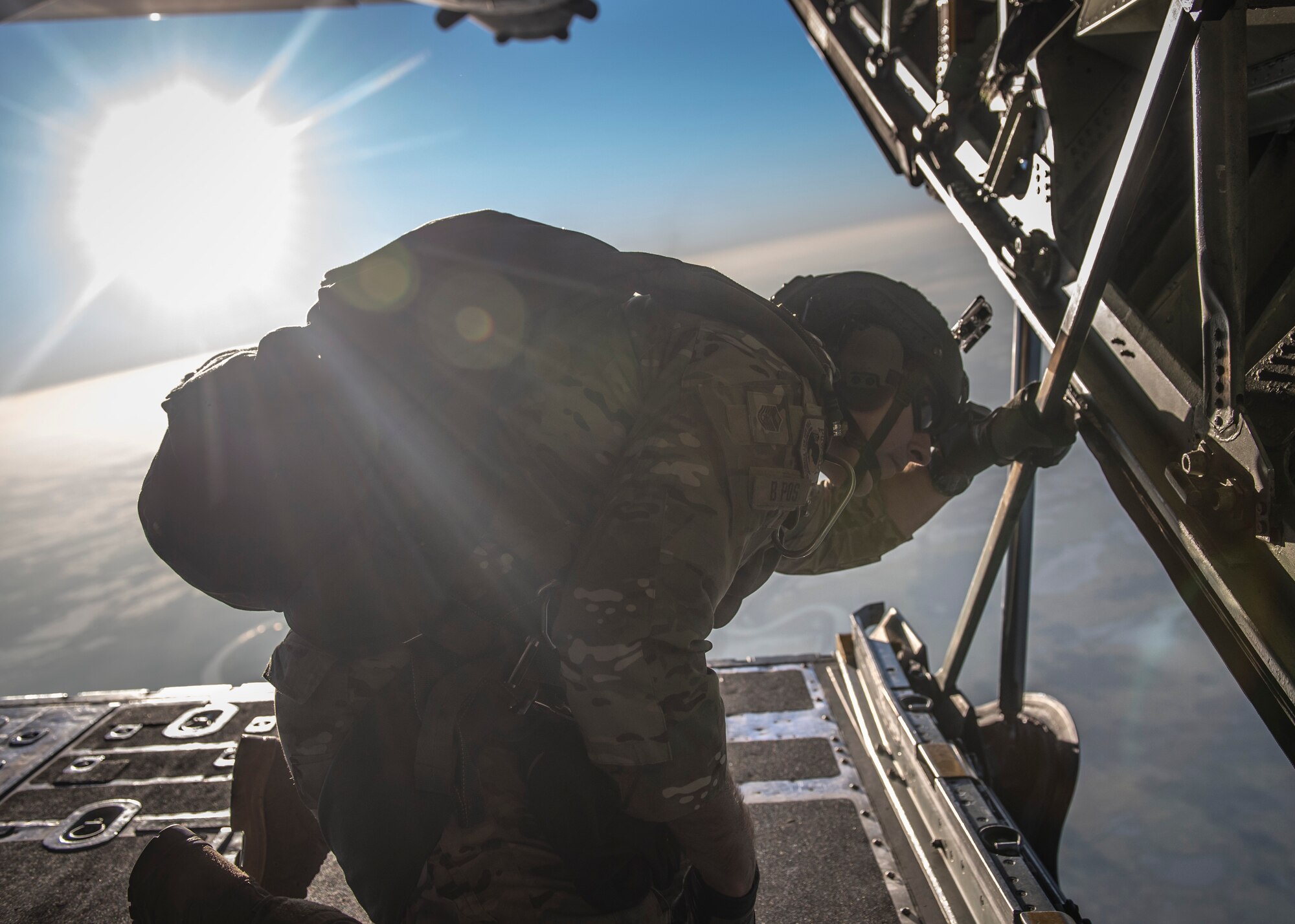 A U.S. Airman looks out the back of a C-130 Hercules before a parachute drop during exercise Cope South over Bangladesh, Nov. 9, 2013. Approximately 80 U.S. Airmen and 3 C-130s are teaming up with Bangladeshi Airmen to exchange airlift expertise through a series of missions and subject-matter expert exchanges. (U.S. Air Force photo by Captain Raymond Geoffroy/Released)