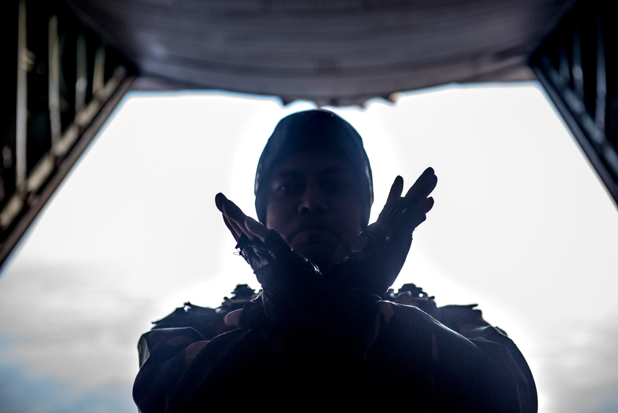 A Bangladeshi Commando signals a team of paratroopers aboard a U.S. C-130 Hercules during exercise Cope South over Bangladesh, Nov. 9, 2013. Cope South is designed to provide Bangladeshi and U.S. forces the opportunity to strengthen relations and promote interoperability. (U.S. Air Force photo by Captain Raymond Geoffroy/Released)