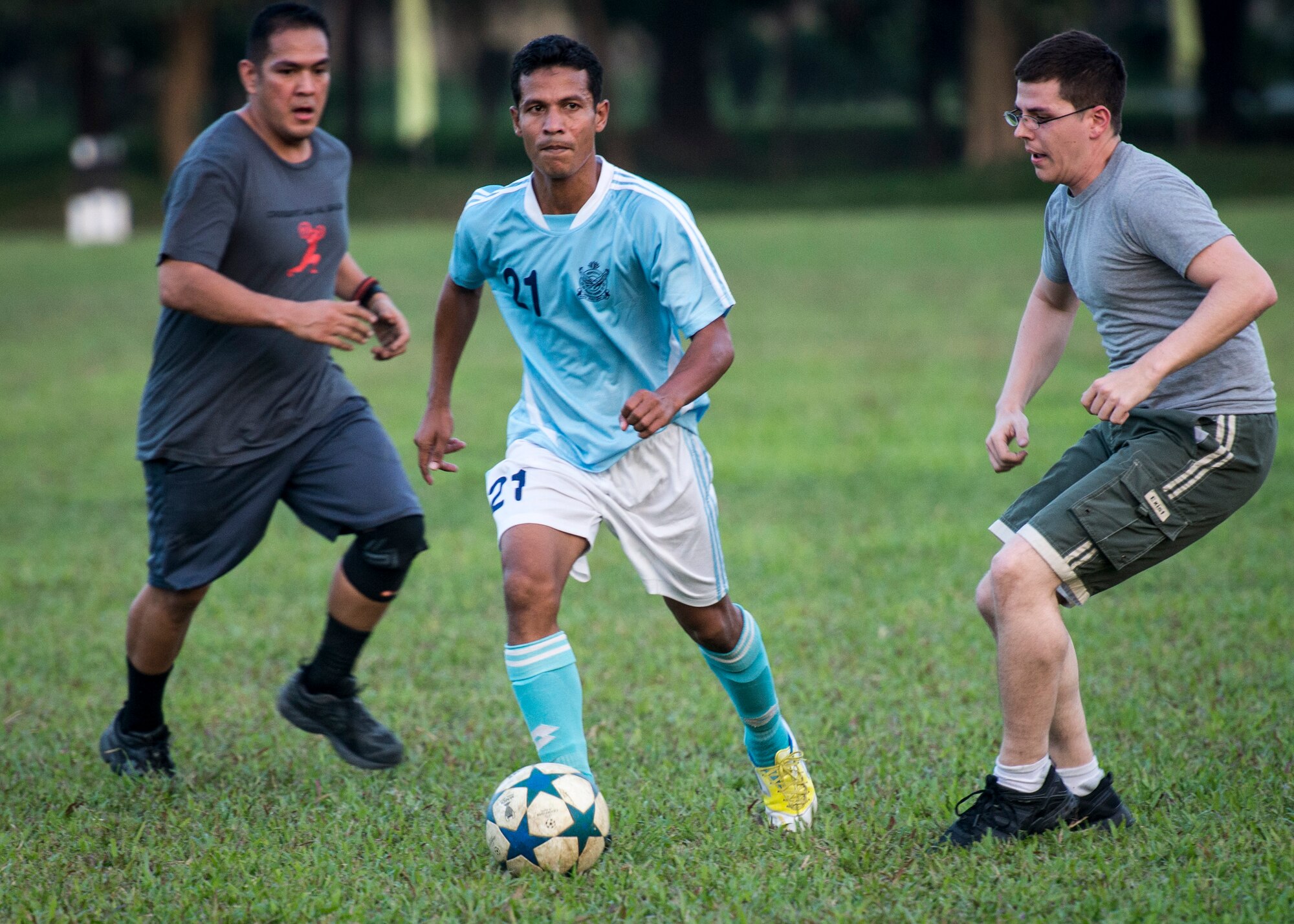 A member of the official Bangladesh Air Force soccer team drives past U.S. Airmen from Yokota Air Base, Japan during a match at Bangabandhu Air Base, Bangladesh, Nov. 8, 2013. The U.S. Airmen found themselves outmatched by the professional players, but built bonds of friendship with their Bangladeshi counterparts during the match. (U.S. Air Force photo by Captain Raymond Geoffroy/Released)