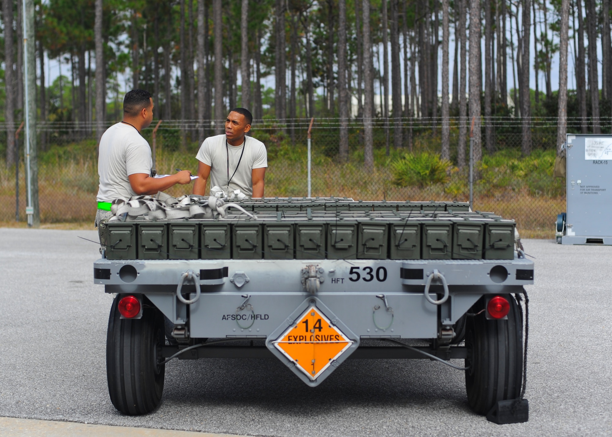 Senior Airmen Joel Ramos and Christopher Williams, 1st Special Operations Equipment Maintenance Squadron munitions crew chiefs, discuss the contents of a munitions trailer at Hurlburt Field, Fla., Nov. 6, 2013. Crew members loaded each trailer to meet specific mission requirements. (U.S. Air Force photo/Staff Sgt. John Bainter)