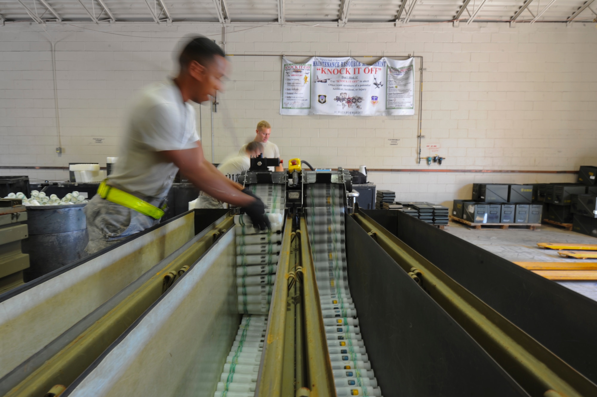 The munitions maintenance crew feeds 25mm rounds through a machine at Hurlburt Field, Fla., Nov. 6, 2013. The crew stored all unfired rounds for later use. (U.S. Air Force Photo/Staff Sgt. John Bainter)