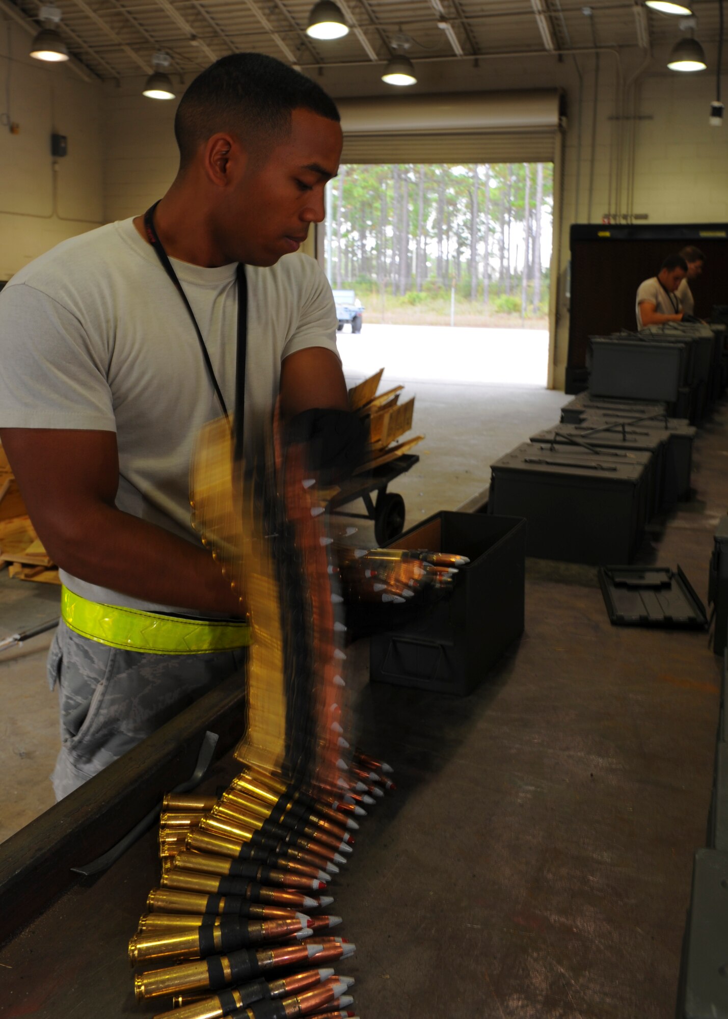 Senior Airman Christopher Williams, 1st Special Operations Equipment Maintenance Squadron munitions crew chief, loads .50-caliber ammunition cans at Hurlburt Field, Fla., Nov. 6, 2013. Williams loaded the ammunition in a custom configuration per the air crew’s preference. (U.S. Air Force photo/Staff Sgt. John Bainter)