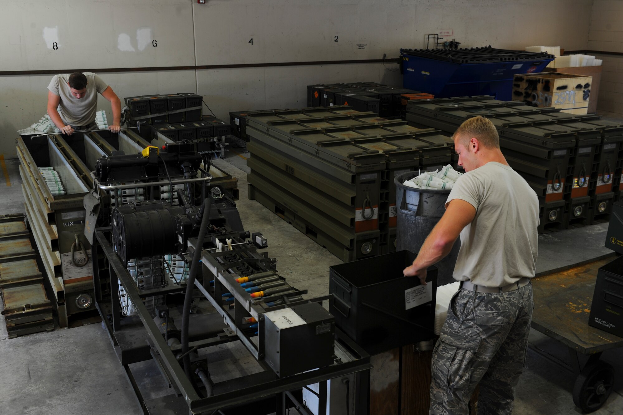 Munitions maintenance crew members unload 25mm rounds at Hurlburt Field, Fla. Nov. 6, 2013. Crew members placed live munitions, which were removed from plastic sleeves, into containers for storage. (U.S. Air Force photo/Staff Sgt. John Bainter)