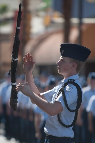 An Air Force Junior ROTC cadet, performs drill on 4th Street during the Las Vegas Veterans Day Parade Nov. 11, 2013, in Las Vegas.  Brig. Gen. Stephen Whiting, U.S. Air Force Warfare Center vice commander, provided opening remarks and sat at the review stand during the parade, Nellis Air Force Base Honor Guard members posted the colors and redeploying Airmen also participated in the event. (U.S. Air Force photo by Staff Sgt. Christopher Hubenthal)