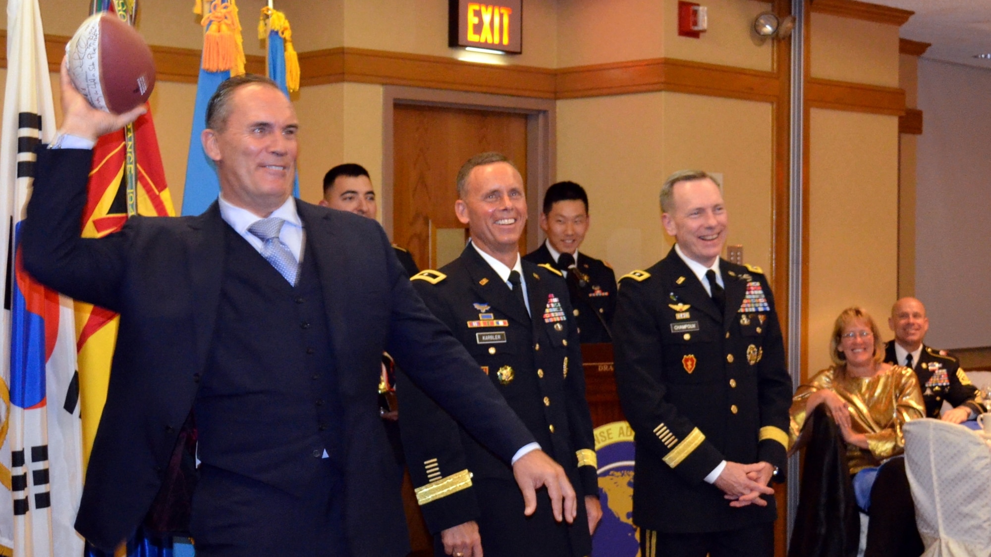 OSAN AB, Republic of Korea – Riki Ellison (left), chairman and founder of the non-profit Missile Defense Advocacy Alliance and three-time Superbowl champion with the San Francisco 49ers, throws an autographed football to one of the Peninsula Missile Defenders of the Year at a banquet held in Seoul, Nov. 8th. Also pictured, from left to right are Brig. Gen. Daniel Karbler, commanding general of the 94th Army Air and Missile Defense Command and Lt. Gen. Bernard Champoux, commanding general of Eighth Army. (U.S. Army photo by Spc. Shawn Denham, 35th ADA Public Affairs)
