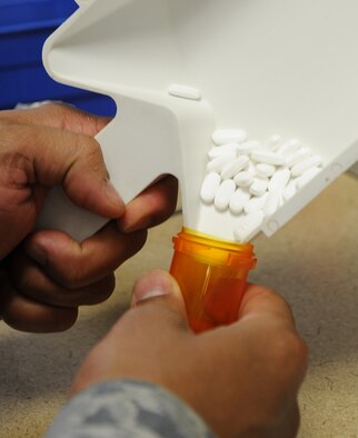 Staff Sgt. Raphael Morales, 92nd Medical Group pharmacy technician, fills a bottle with medication at Fairchild Air Force Base, Wash., Nov. 12, 2013. The pharmacy processes an average of 400-500 scripts a day. (U.S. Air Force photo by Airman 1st Class Janelle Patiño/Released)