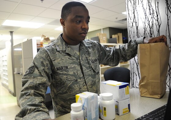 Staff Sgt. William Martin, 92nd Medical Group pharmacy technician, puts the prescribed medications in a bag for a patient at Fairchild Air Force Base, Wash., Nov. 12, 2013.The pharmacy serves over 30 thousand beneficiaries along with nine clinics that belong to the 92nd MDG. (U.S. Air Force photo by Airman 1st Class Janelle Patiño/Released)
