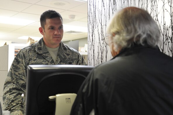 Capt. Jason Barkemeyer, 92nd Medical Group pharmacist, gives a patient instructions on when and how to take the prescribed medication at Fairchild Air Force Base, Wash., Nov. 12, 2013. A pharmactist and patient consultation is one of the many steps involved with the pharmacy. (U.S. Air Force photo by Airman 1st Class Janelle Patiño/Released)
