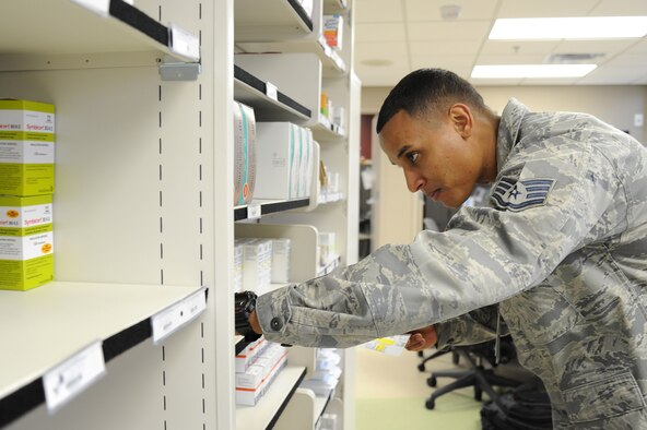 Staff Sgt. Raphael Morales, 92nd Medical Group pharmacy technician, searches for a patient's medication at the pharmacy at Fairchild Air Force Base, Wash., Nov. 12, 2013. The pharmacy processes an average of 400-500 scripts a day. (U.S. Air Force photo by Airman 1st Class Janelle Patiño/Released)