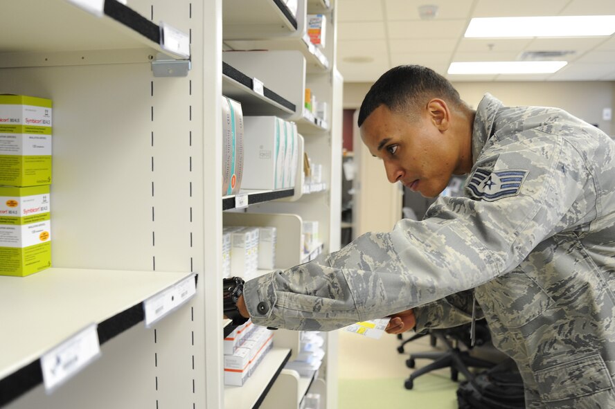 Staff Sgt. Raphael Morales, 92nd Medical Group pharmacy technician, searches for a patient's medication at the pharmacy at Fairchild Air Force Base, Wash., Nov. 12, 2013. The pharmacy processes an average of 400-500 scripts a day. (U.S. Air Force photo by Airman 1st Class Janelle Patiño/Released)