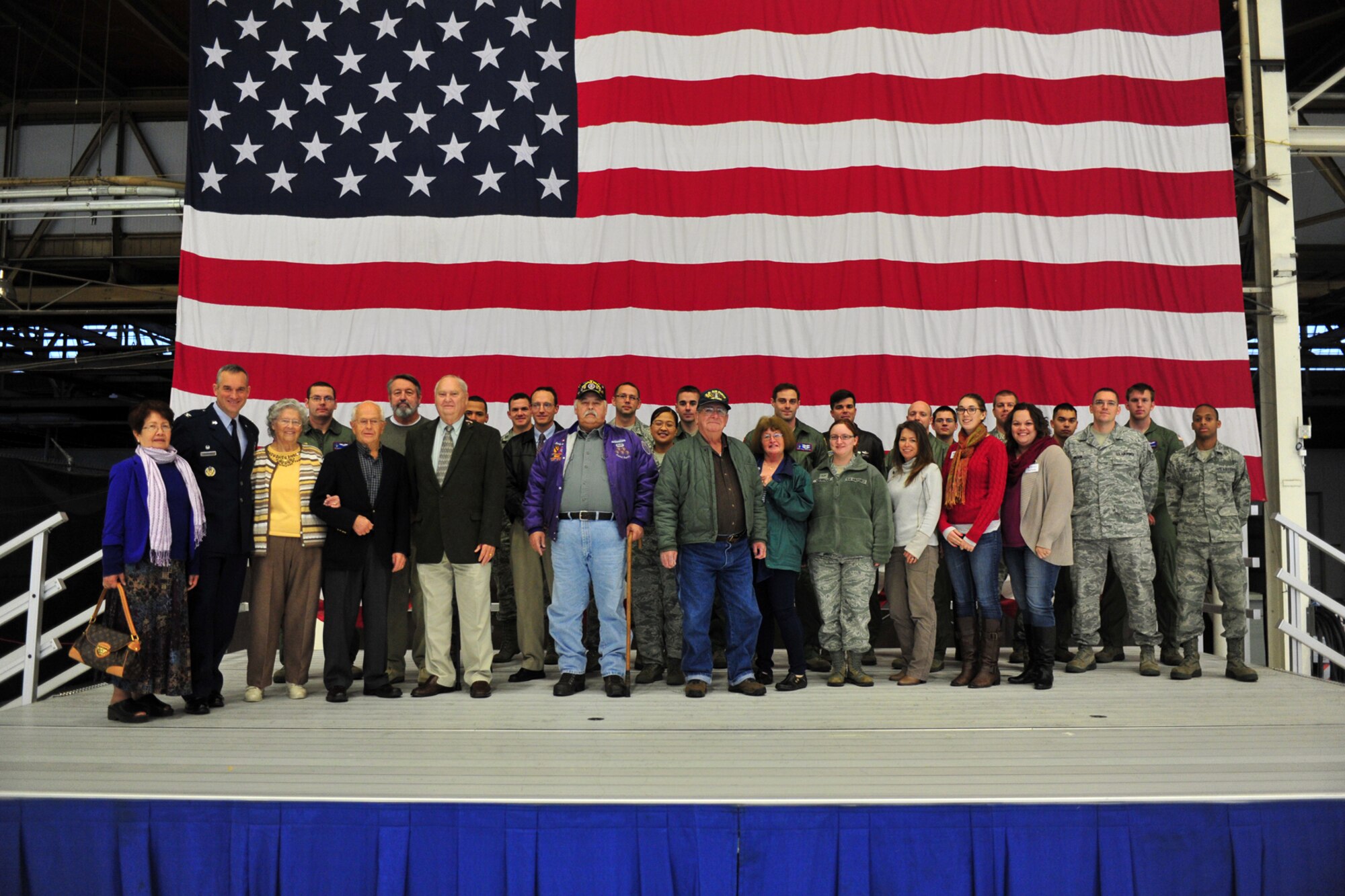 Members of Team Fairchild and the community pose for a group photo during the base’s Veterans Day event held in Hangar 2 at Fairchild Air Force Base, Wash., Nov. 7, 2013. (U.S. Air Force photo by Senior Airman Taylor Curry/Released)