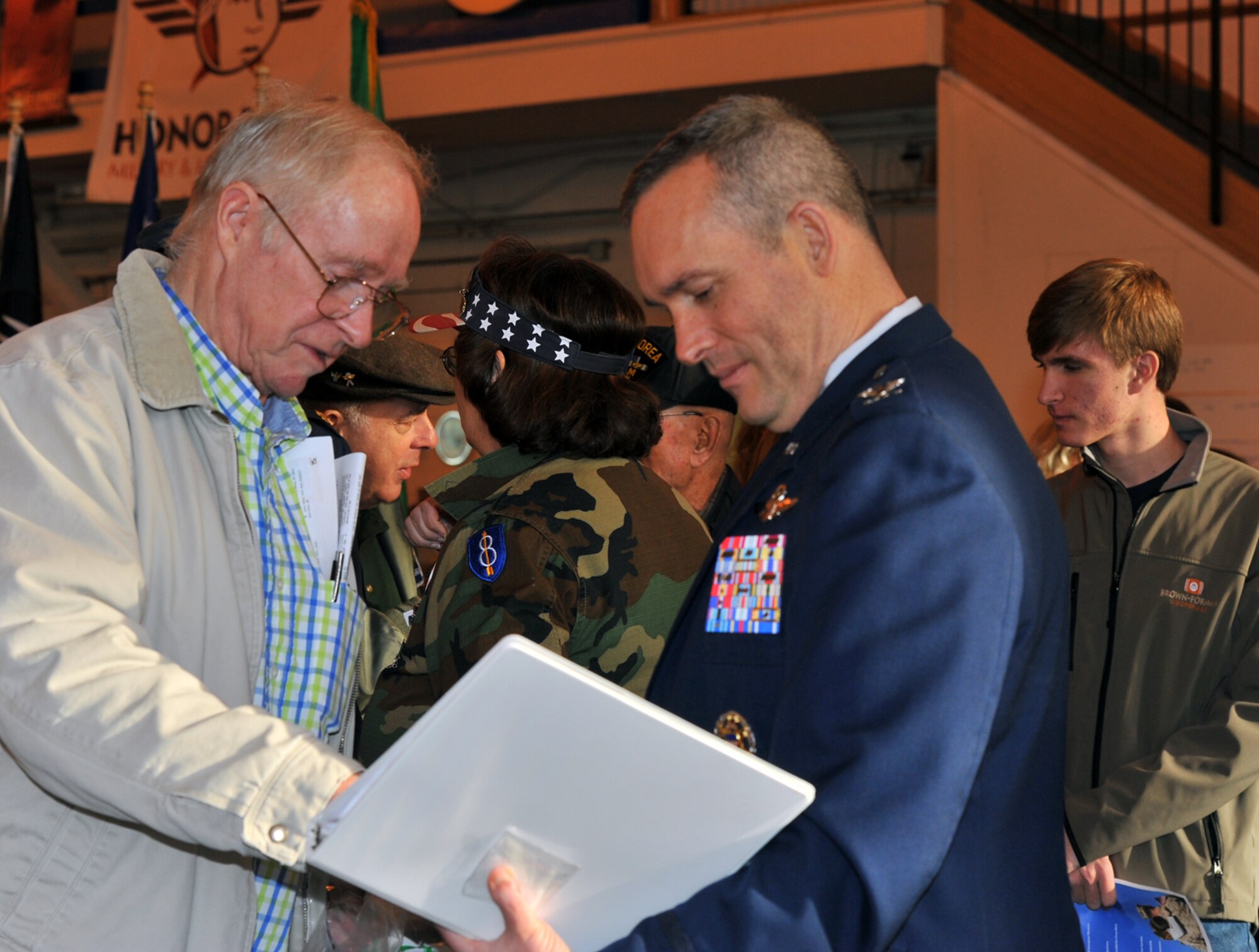 Col. Brian Newberry, 92nd Air Refueling Wing commander, meets with a local veteran after the Veterans Day ceremony Nov. 11, 2013, at Felts Field in Spokane, Wash. During the ceremony, men and women received recognition for their service and sacrifice. (U.S. Air Force photo by Staff Sgt. Veronica Montes/Released)