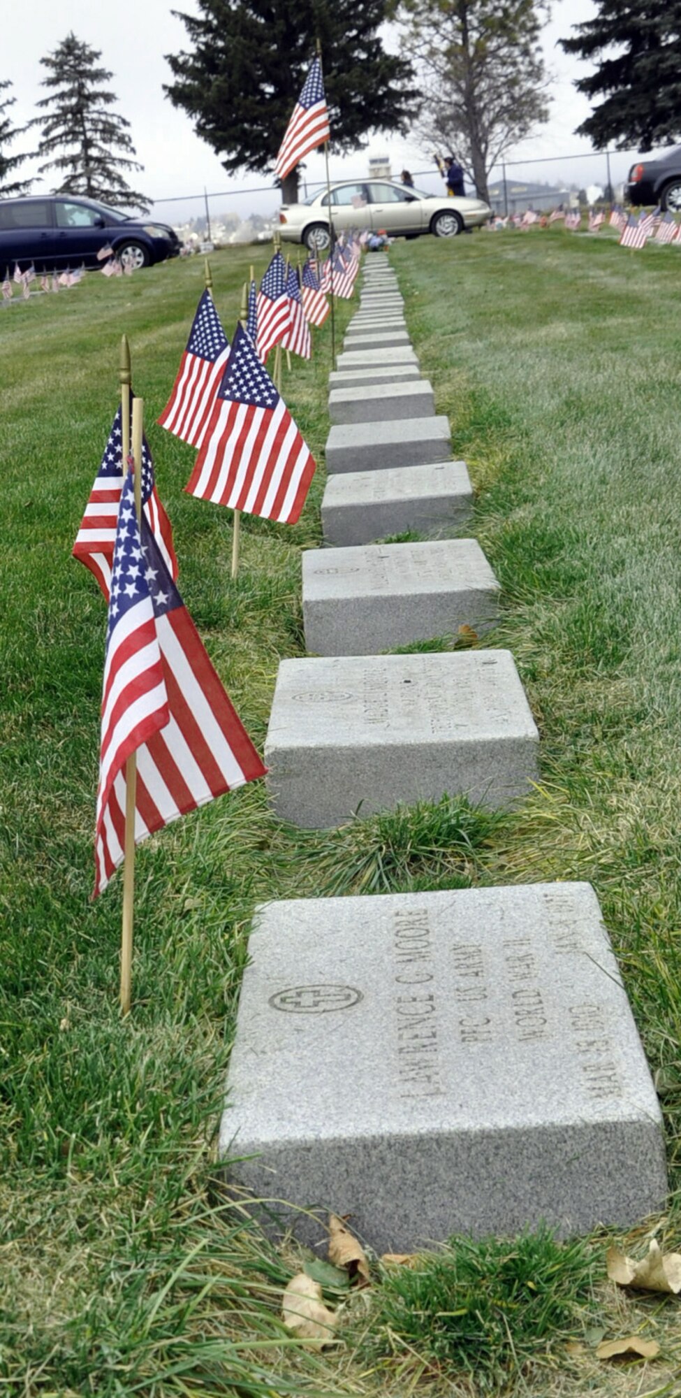 131111-F-CP692-026 American Flags line the headstones at Beth El Cemetery, Cheyenne, Wyo., in a tribute for Veterans Day Nov. 11. Veterans Day is not only a day to remember those who returned from war, but to show respect for the many who did not. (U.S. Air Force photo by 1st Lt. Eydie Sakura)