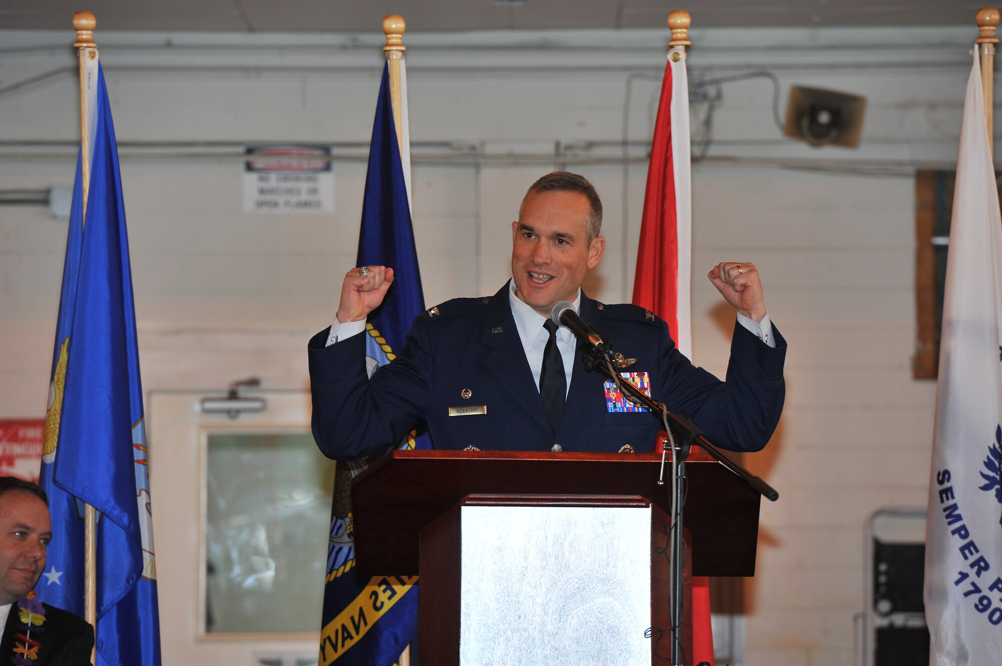 Col. Brian Newberry, 92nd Air Refueling Wing commander, cheers on the crown during the Veterans Day ceremony Nov. 11, 2013, at Felts Field in Spokane, Wash. Newberry gave his appreciation and said veterans and their families made America. (U.S. Air Force photo by Staff Sgt. Veronica Montes/Released)