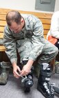 131108-F-GZ967-014 Capt. Phillip Barras, 90th Medical Operations Squadron, tightens up a pair of ski boots at Outdoor Recreation Nov. 8, 2013. Barras joined many others as they got fitted for their winter gear before the season begins. Although the “get Your Gear on” event has passed, Airmen are still able to visit ODR in order to get sized for winter gear. (U.S. photo by Airman 1st Class Brandon Valle)
