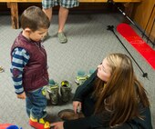 131108-F-GZ967-008 Kelly Palmer, Outdoor Recreation employee, helps Landon Lieber, 3, son of Master Sgt. Gabriel Lieber, 90th Missile Wing Command Post, as he tries on a pair of ski boots during Outdoor Recreation’s “Get Your Gear on” event Nov. 8.  The event was designed to allow Airmen and their families to get their sizes for boots, skis, snowboards, and helmets fitted before the beginning of the winter season, allowing for a quick pick-up during the season. (U.S. photo by Airman 1st Class Brandon Valle)