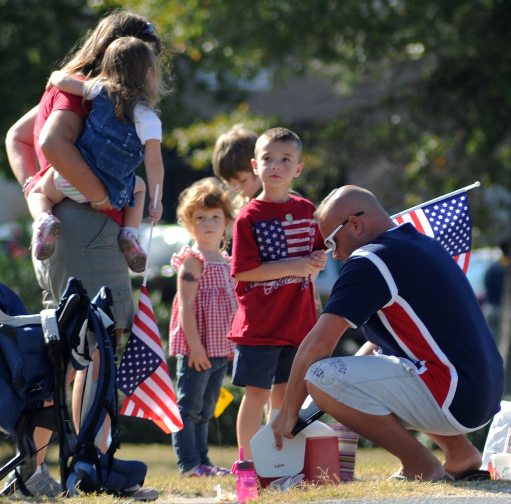 A service member and his family prepare themselves for the Veteran's Day parade in Mary Esther, Fla., Nov. 11, 2013. Families from across Okaloosa County gathered at the parade to celebrate Veteran’s Day. (U.S. Air Force photo/Senior Airman Kentavist P. Brackin)