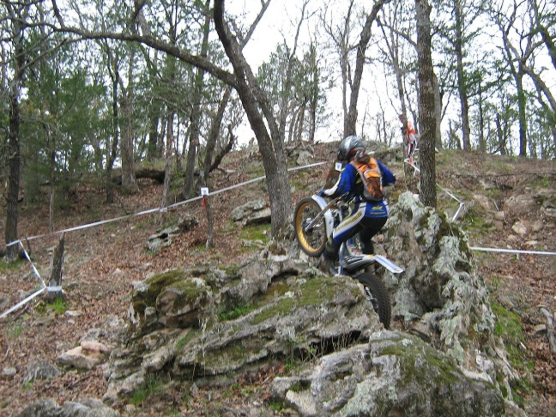 Laura Peters, 27th Special Operations Civil Engineer Squadron environmental restoration manager, shows off her trial-riding skills at Red River in Bulcher, Texas. To prepare for MotoTrials competitions, Peters trains three days a week and rides one day per weekend. (U.S. Air Force photo/Courtesy photo)