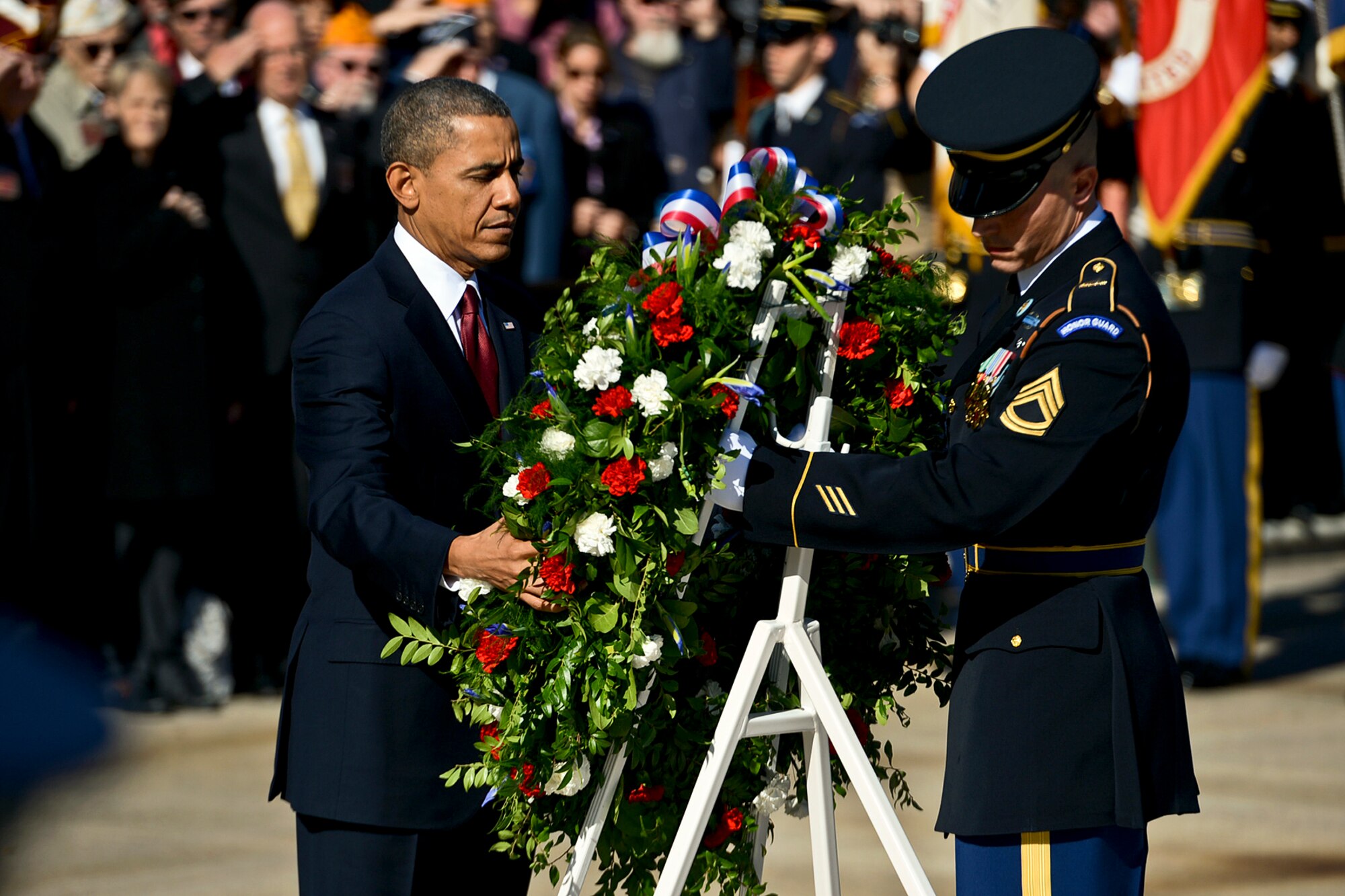 President Barack Obama places a wreath at the Tomb of the Unknowns with the help of an honor guard Soldier during a Veterans Day ceremony at Arlington National Cemetery in Arlington, Va., Nov. 11, 2013. (DOD photo by EJ Hersom/Released)