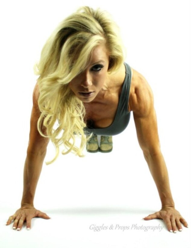 U.S. Air Force Senior Airman Danielle Gomrick, 27th Special Operations Medical Operations Squadron aerospace medical technician, performs a pushup during a photo shoot in 2013. After months of intensive training, Gomrick became a sponsored figure competitor after placing second in her first-ever competition. (Courtesy Photo)