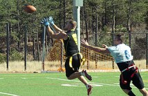131109-F-GZ967-103 Senior Airman Chris Russell, 90th Security Forces Group, leaps into the air as he tries to catch the ball during a flag football game at the United States Air Force Academy Nov.9 while 2nd Lt. Brian Lindsay, USAFA Prep School assistant football coach, attempts to cover him. (U.S. Air Force photo by Airman 1st Class Brandon Valle)