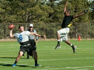 131109-F-GZ967-044 Airman 1st Class Devin Harris, 90th Maintenance Operations Squadron, jumps to impede the vision of the United States Air Force Academy quarterback, 2nd Lt. Brian Lindsay, USAFA Prep School assistant football coach, during a game at the Academy Nov. 9. The game was to determine whose base would have their name etched into the Rocky Mountain Regional Military Championship plaque, which has the names from the winner of six different sports championships held yearly.  (U.S. Air Force photo by Airman 1st Class Brandon Valle)