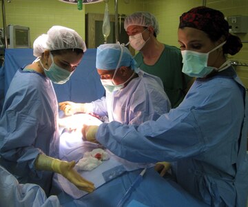 Members of Joint Task Force-Bravo's Mobile Surgical Team (MST) conduct a procedure at Hospital Escuela in Tegucigalpa, Honduras, Nov. 5, 2013.  The MST conducted operations at the hospital as part of a Medical Readiness Training Exercise and completed four surgeries and consulted on three cases.  (Courtesy photo)