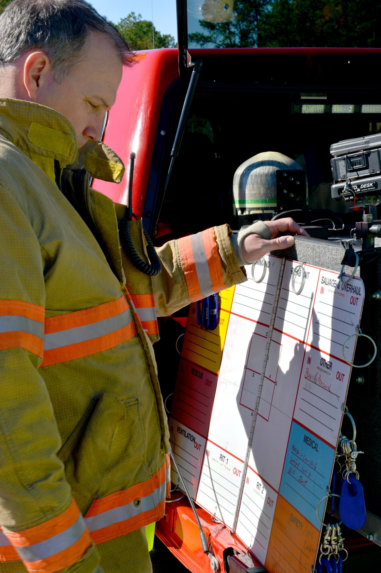 A firefighter from the 20th Civil Engineering Squadron fire department reviews a board at the mobile command post during a major accident response exercise, Shaw Air Force Base S.C., Nov. 8, 2013. The fire department and other on base emergency personnel responded to a simulated suspicious vehicle and a public health emergency during the exercise. (U.S. Air Force photo by Airman 1st Class Jensen Stidham)