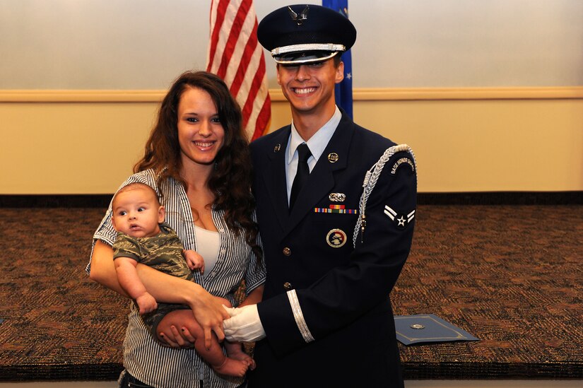 U.S. Air Force Airman 1st Class Matthew Mendez, 633rd Logistics Readiness Squadron fuels distribution operator, greets his wife, Chanse and son, Matthew Jr., after the Langley Air Force Base Honor Guard graduation ceremony at Langley Air Force Base, Va., Aug. 27, 2013. Mendez was selected by his leadership to represent the installation in the base honor guard after demonstrating outstanding job performance. (U.S. Air Force photo by Senior Airman Brittany Paerschke-O’Brien/Released)
