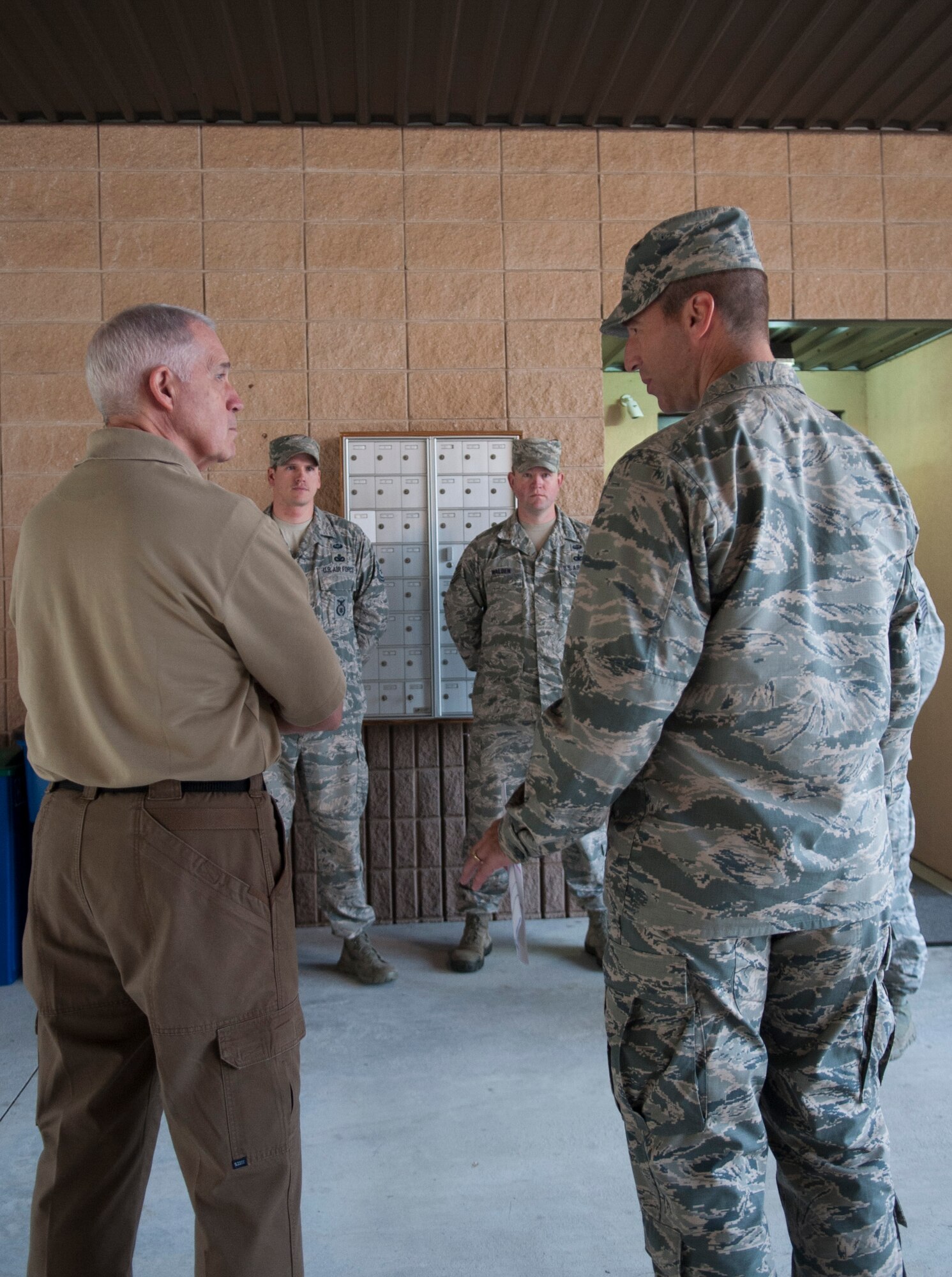 Retired U.S. Air Force Col. John Probst, Security Forces Association executive director, and Col. Paul Kasuda, 820th Base Defense Group commander, meet with members of the 820th BDG intelligence staff during a visit at Moody Air Force Base, Ga., Nov. 7, 2013. Airmen explained to Probst their jobs and how intelligence enhances the group’s mission. (U.S. Air Force photo by Airman 1st Class Sandra Marrero/Released)

