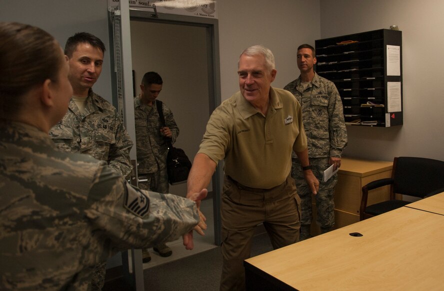 Retired U.S. Air Force Col. John Probst, Security Forces Association executive director, greets an 820th Base Defense Group personnel specialist at Moody Air Force Base, Ga., Nov.7, 2013. The Security Forces Association is a global organization of security forces members that aims to enhance camaraderie amongst members and capture a definitive history of the career field. (U.S. Air Force photo by Airman 1st Class Sandra Marrero/Released)
