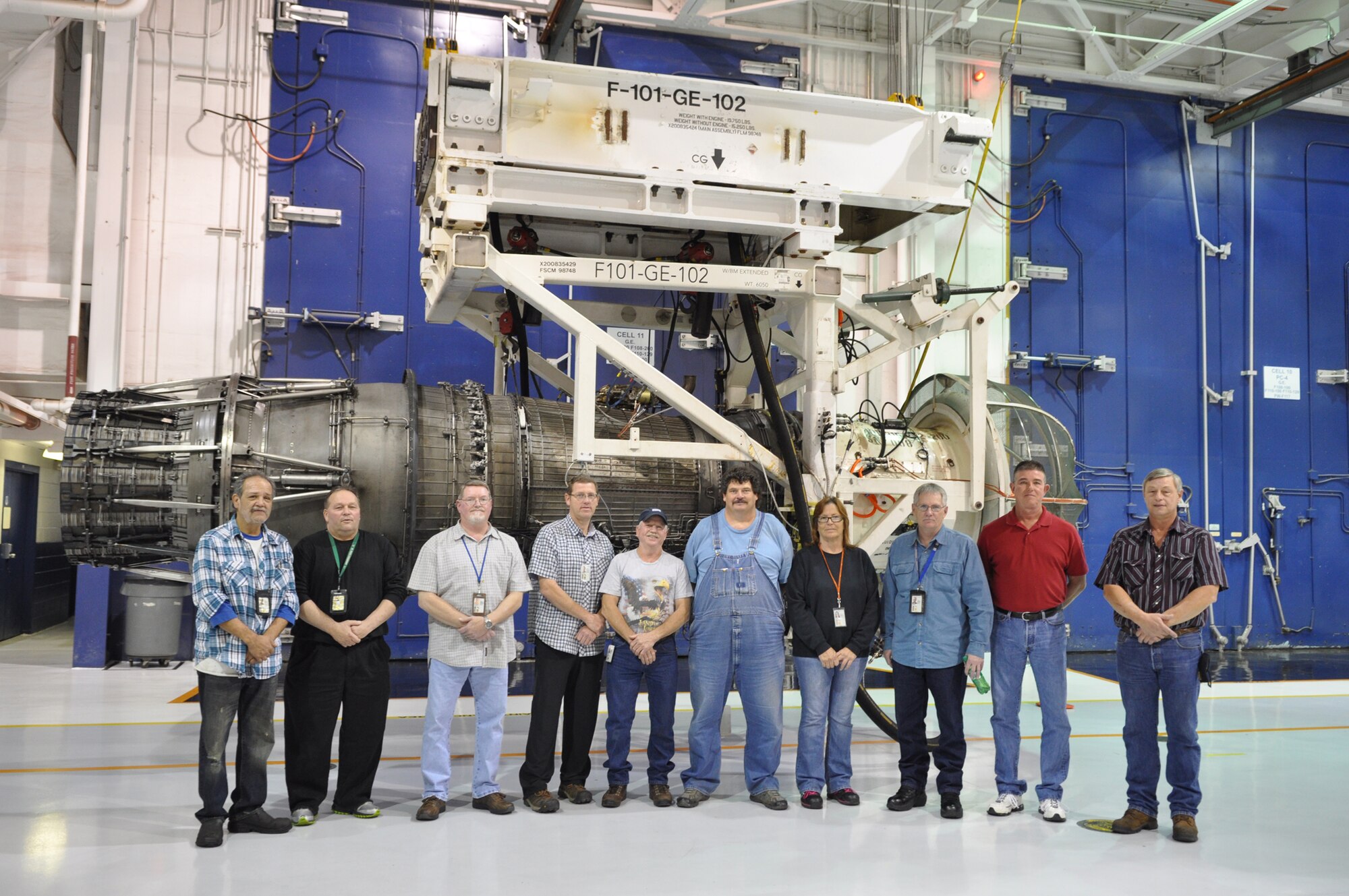 Pictured in front of the F101 Engine are, from left, Roy Kniffin, Randall Brock, Mike Fullbright, Robbie Robinson, Freddie Danker, Mark Smith, Debbie Phillips, Robert Robinson, Alan Houk and Lloyd Fincher Jr. Not pictured is Hugh Crow. All are retiring Nov. 30. (Air Force photo by April McDonald)