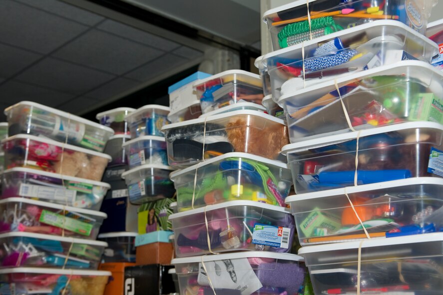 Plastic containers filled with gifts like toys and socks sit stacked on a table at the chapel on Hurlburt Field, Fla., Nov. 8, 2013.  The containers are sent to children worldwide in support of “Operation Christmas Child.” National Collection Week for Operation Christmas Child is Nov. 18 through 25. (U.S Air Force photo/Senior Airman Naomi Griego)