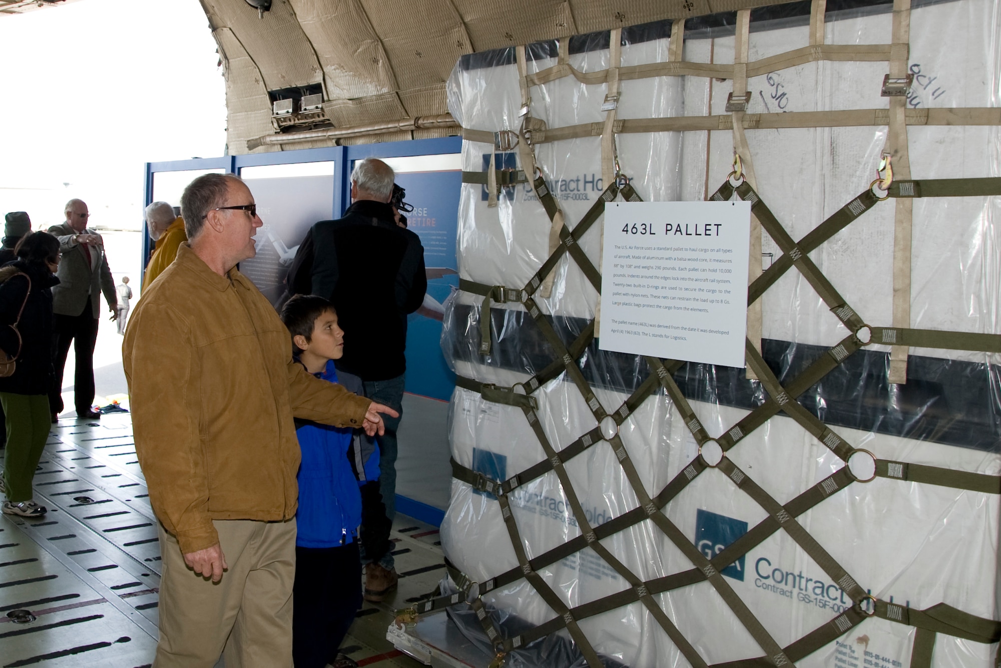 Christopher Sukosky, from Wilmington Del., and his son, Dylan, read about pallets and the capacity of the C-5A Galaxy Nov. 9, 2013, at the AMC museum on Dover Air Force Base, Del. Sukosky was the first to board the aircraft and has memories of his dad talking about the C-5. (U.S. Air Force photo/Senior Airman Jared Duhon)