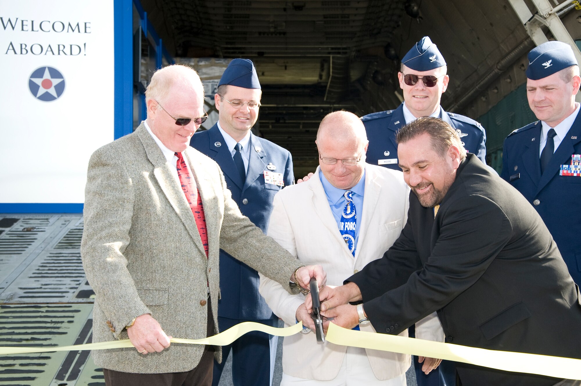 Members of the Air Mobility Command Museum, 164th Airlift Wing Tennessee Air National Guard and 436th Airlift Wing cut the ribbon allowing public access to the first C-5A Galaxy to be in a museum Nov. 9, 2013, at the AMC museum on Dover Air Force Base, Del. The transformation took three months and nine aircraft had to be moved to make room for C-5. (U.S. Air Force photo/Senior Airman Jared Duhon) 

