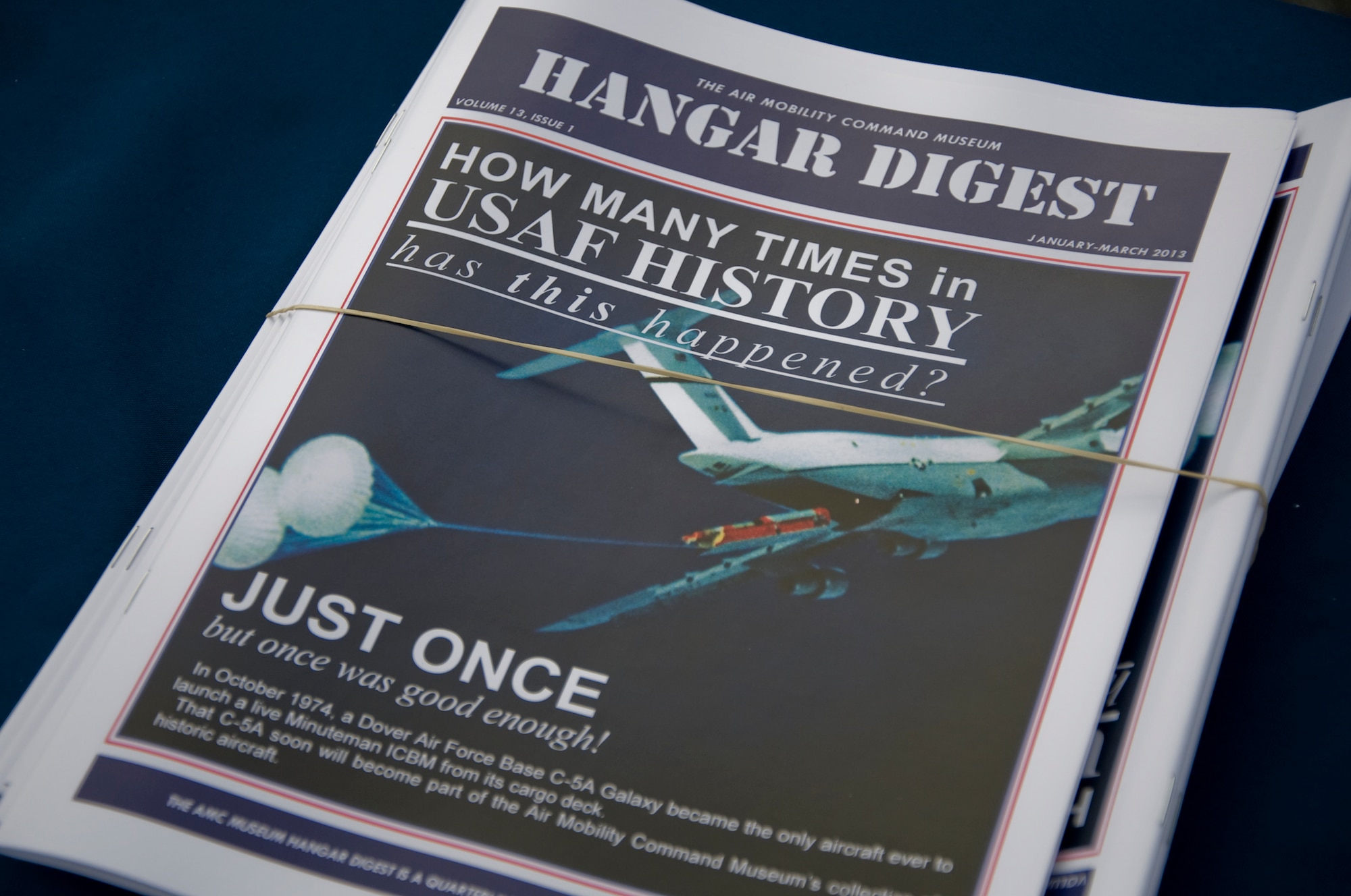 A Hangar Digest newsletter sits in the  Air Mobility Command museum  Nov. 9, 2013, at the AMC museum on Dover Air Force Base, Del. This issue was about the capability of a C-5 to drop a ballistic missile. The C-5 was the first and only aircraft to make the feat. (U.S. Air Force photo/Senior Airman Jared Duhon)