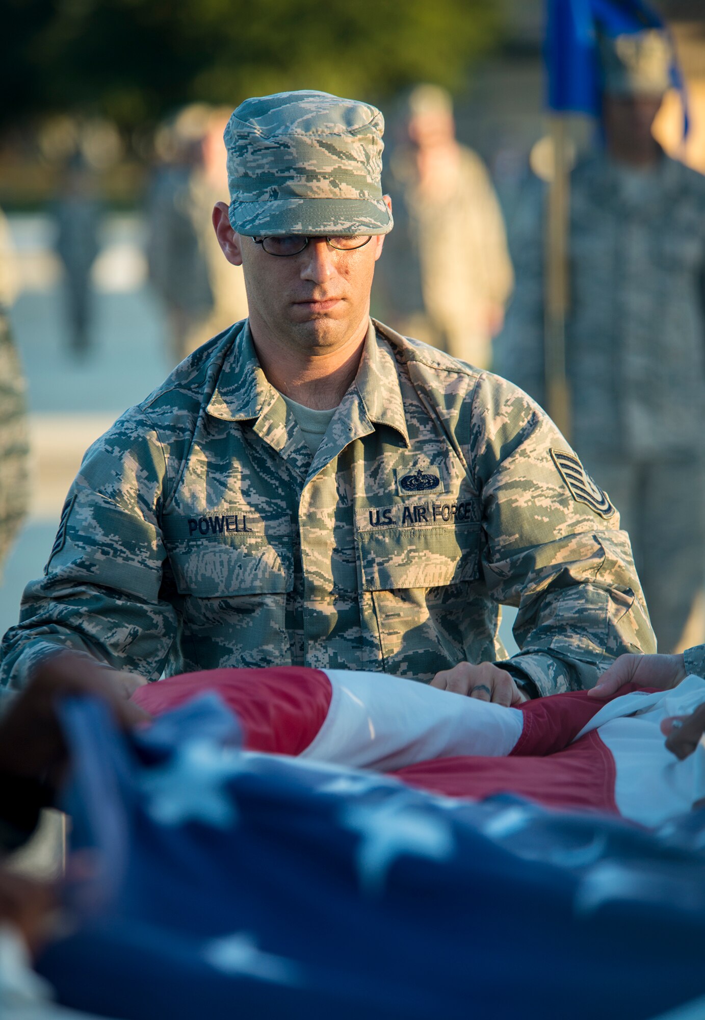 U.S. Air Force Tech. Sgt. Gregory Powell, 23d Communications Squadron radio frequency transmissions NCO in charge, folds the flag at Moody Air Force Base, Ga., Nov. 8, 2013. Powell led a six-man flag detail of 23d CS Airmen during a Veterans Day ceremony. (U.S. Air Force photo by Airman 1st Class Ryan Callaghan/Released)
