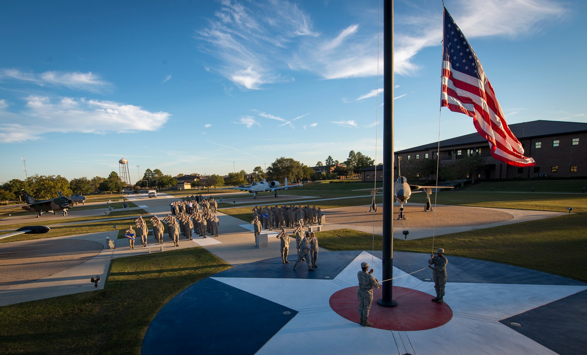 Airmen from the 23d Mission Support Group and the 23d Wing staff agency salute as the flag is lowered at Moody Air Force Base, Ga., Nov. 8, 2013. The Airmen stood in formation while the flag was lowered and folded as part of a ceremony to honor veterans. (U.S. Air Force photo by Airman 1st Class Ryan Callaghan/Released)
