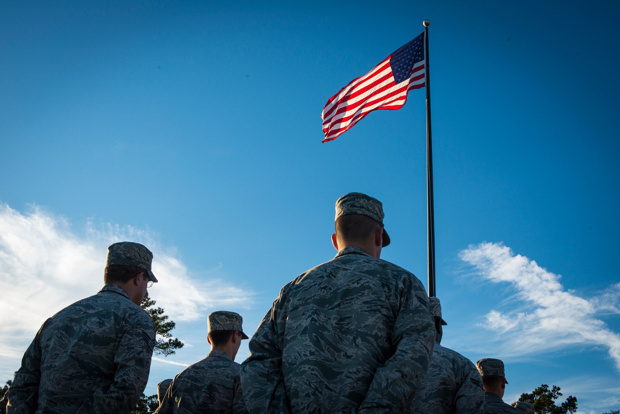 U.S. Air Force Airmen from the 23d Communications Squadron stand in a flight waiting for the playing of retreat at Moody Air Force Base, Ga., Nov. 8, 2013. Airmen from the 23d Mission Support Group participated in a flag-folding ceremony to honor veterans. (U.S. Air Force photo by Airman 1st Class Ryan Callaghan/Released)
