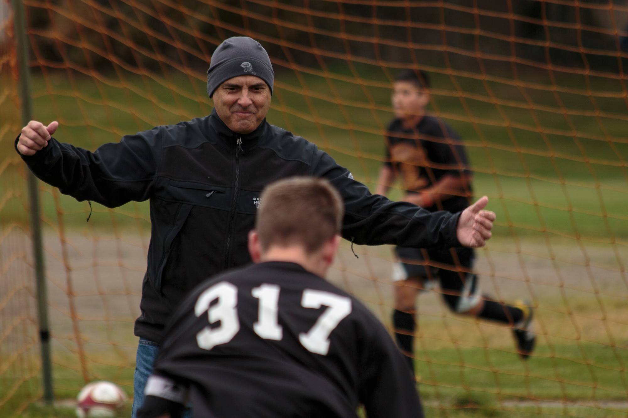 Chaplain (Maj.) Pierre Allegre, 446th Airlift Wing chaplain, coaches boys and girls' soccer for a middle school in Lacey, Wash., Oct. 30. Allegre used to play soccer in high school and is one of his passions in his civilian life. He's also a pastor for a church in Lacey. He said Veterans' Day is a reminder of why he puts on his Air Force uniform. (U.S. Air Force Reserve photo by Master Sgt. Jake Chappelle)