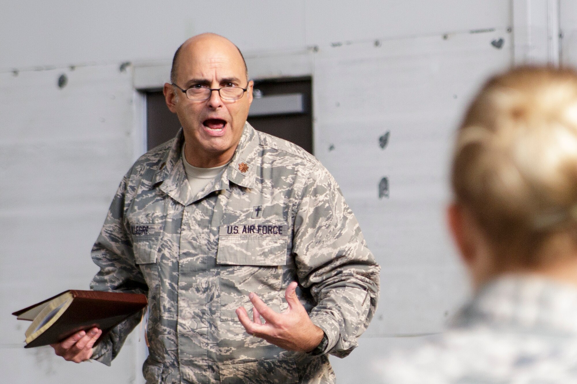 Chaplain (Maj.) Pierre Allegre, the 446th Airlift Wing chaplain, gives a sermon during the Reserve weekend, Nov. 3. The chaplain said Veterans’ Day is a reminder of why he wears his Air Force uniform. (U.S. Air Force Reserve photo by Master Sgt. Jake Chappelle)