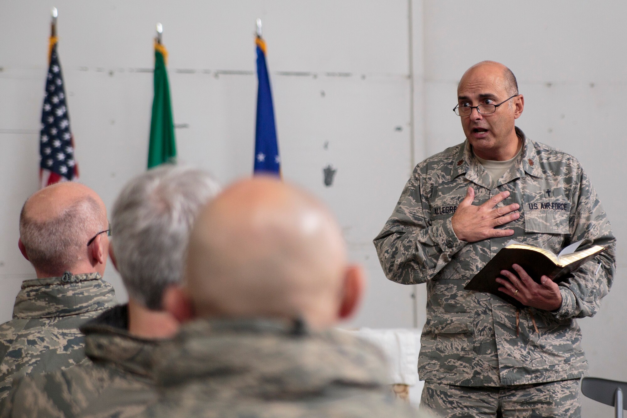 Chaplain (Maj.) Pierre Allegre, the 446th Airlift Wing chaplain, gives a sermon during the Reserve weekend, Nov. 3. The chaplain said Veterans’ Day is a reminder of why he wears his Air Force uniform. (U.S. Air Force Reserve photo by Master Sgt. Jake Chappelle)