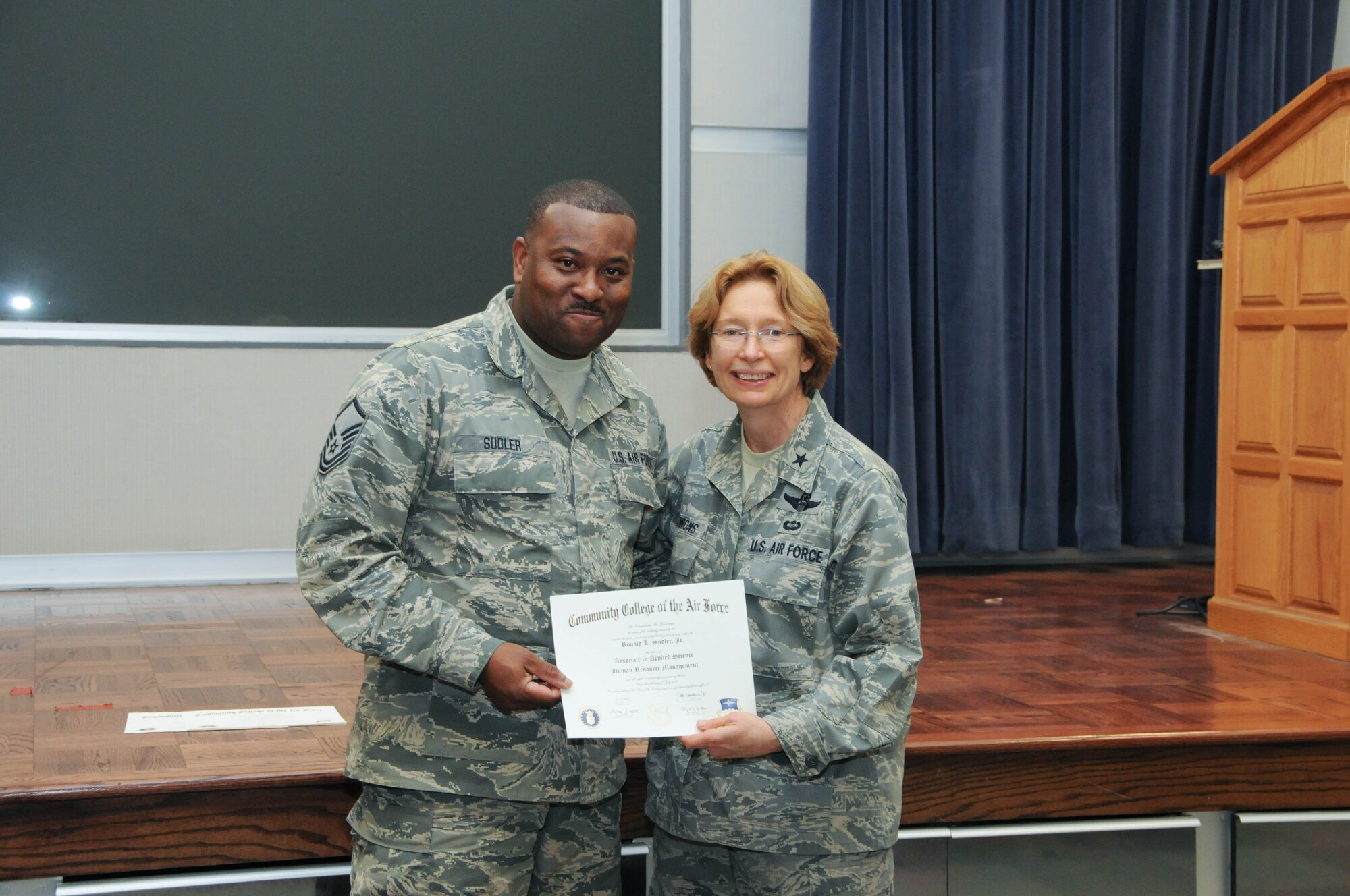 U.S. Air Force Master Sgt. Ronald Sudler, left, a member of the 166th Force Support Squadron, 166th Airlift Wing, receives a certificate from Brig. Gen. Carol Timmons, assistant adjutant general for air, Delaware National Guard to recognize Sudler’s attainment of a Community College of the Air Force associate of applied science degree in human resource management at a CCAF Class of October 2013 graduation ceremony held Nov. 3, 2013 at the New Castle Air National Guard Base, Del. (U.S. Air National Guard photo by Tech. Sgt. Robin Meredith)