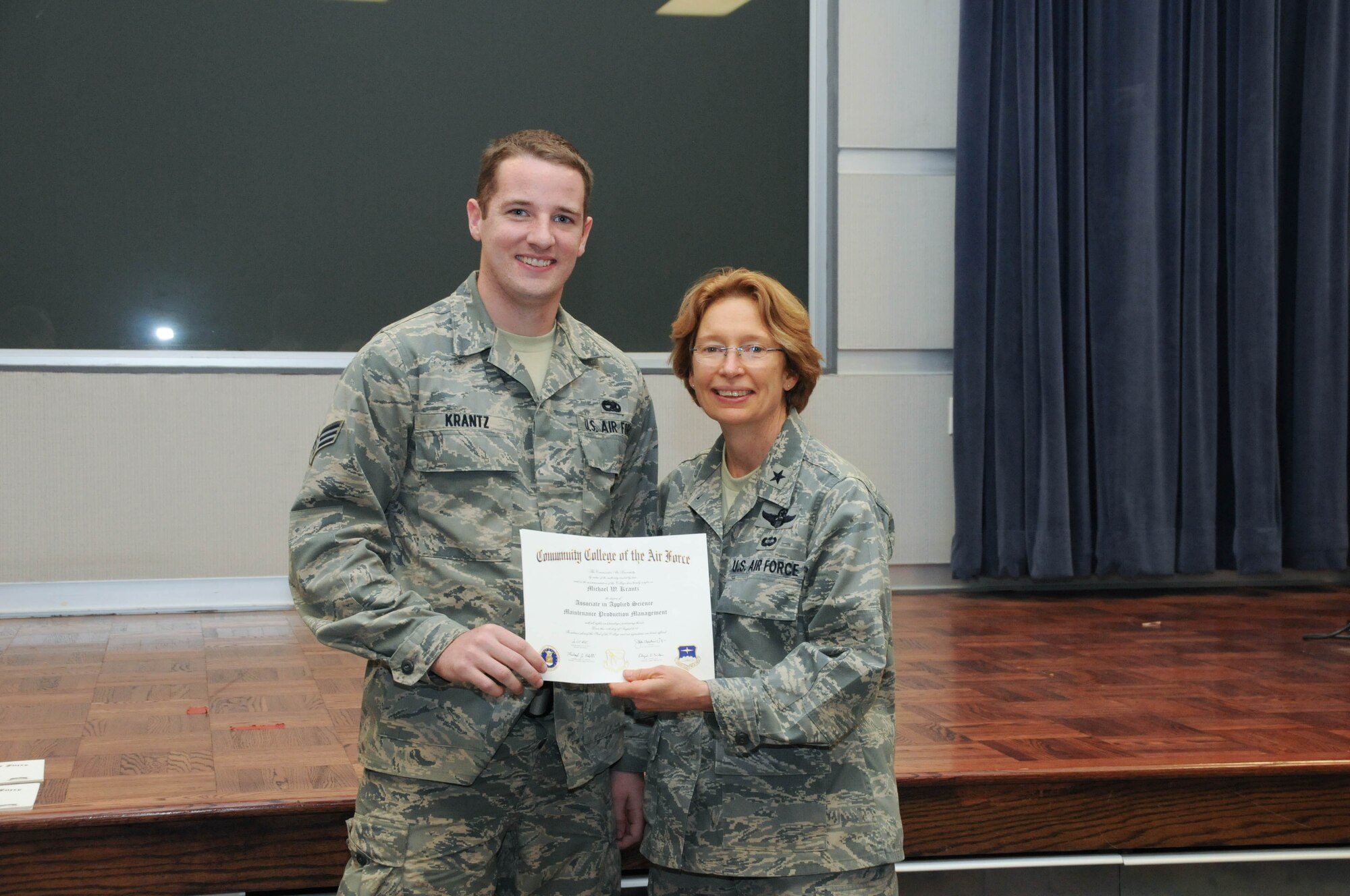 U.S. Air Force Senior Airman Michael Krantz, left, a member of the 166th Maintenance Operations Flight, 166th Airlift Wing, receives a certificate from Brig. Gen. Carol Timmons, assistant adjutant general for air, Delaware National Guard to recognize Krantz’s attainment of a Community College of the Air Force associate of applied science degree in maintenance production management at a CCAF Class of October 2013 graduation ceremony held Nov. 3, 2013 at the New Castle Air National Guard Base, Del. (U.S. Air National Guard photo by Tech. Sgt. Robin Meredith)