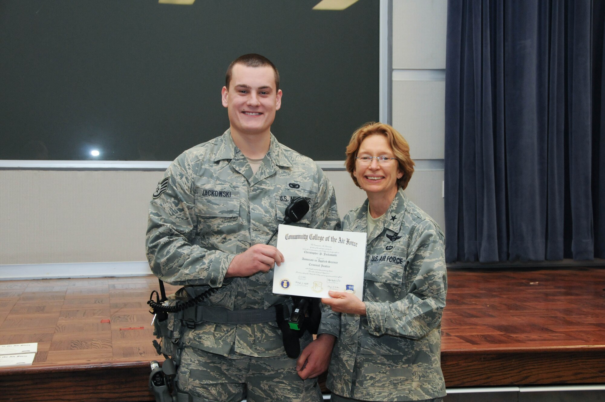 U.S. Air Force Staff Sgt. Christopher Jackowski, left, a member of the 166th Security Forces Squadron, 166th Airlift Wing, receives a certificate from Brig. Gen. Carol Timmons, assistant adjutant general for air, Delaware National Guard to recognize Jackowski’s attainment of a Community College of the Air Force associate of applied science degree in criminal justice at a CCAF Class of October 2013 graduation ceremony held Nov. 3, 2013 at the New Castle Air National Guard Base, Del. (U.S. Air National Guard photo by Tech. Sgt. Robin Meredith)