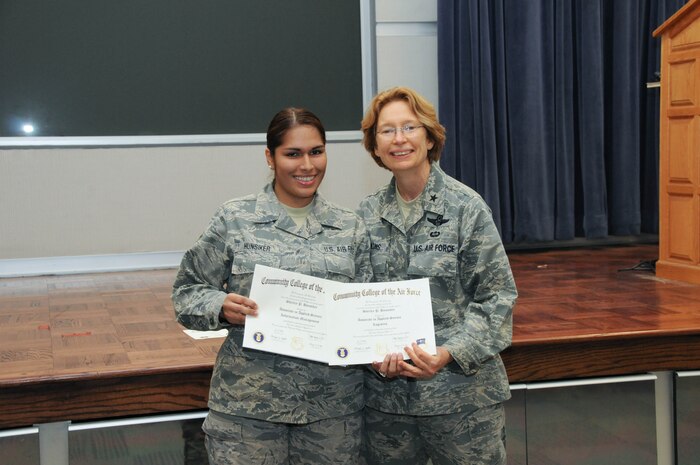 U.S. Air Force Staff Sgt. Shirley Hunsiker, left, a member of the 166th Mission Support Group, 166th Airlift Wing, receives a certificate from Brig. Gen. Carol Timmons, assistant adjutant general for air, Delaware National Guard to recognize Hunsiker’s attainment of a Community College of the Air Force associate of applied science degree in logistics and a second AAS in information management at a CCAF Class of October 2013 graduation ceremony held Nov. 3, 2013 at the New Castle Air National Guard Base, Del. (U.S. Air National Guard photo by Tech. Sgt. Robin Meredith)